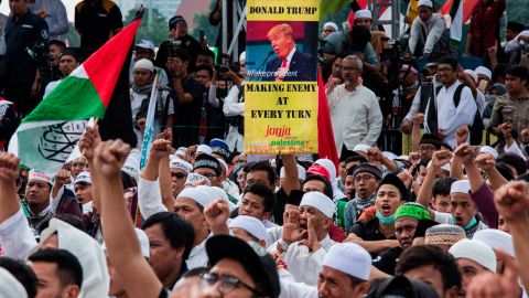 Protesters show banners and shout slogans in the Indonesian capital of Jakarta.
