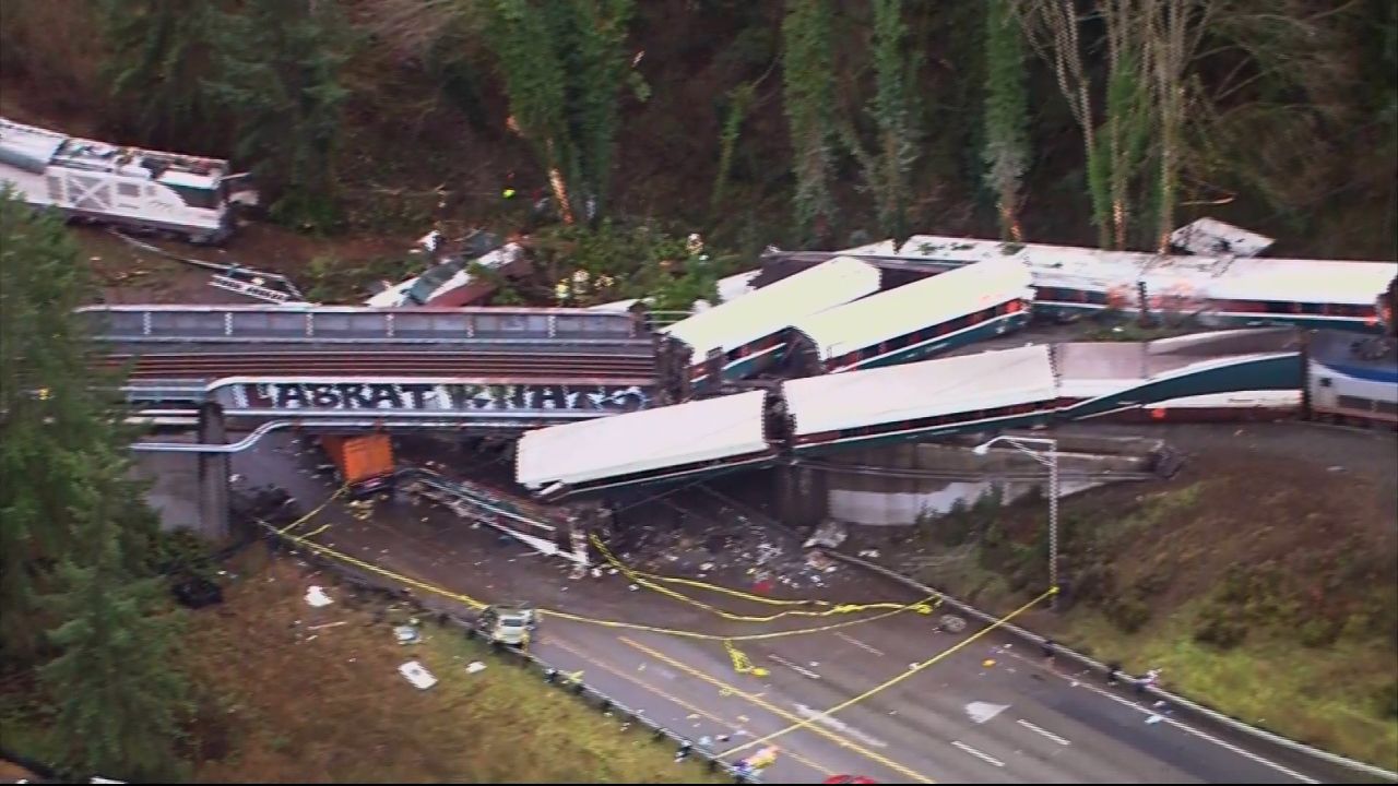Aerial images show the train sprawled across the track and highway on Monday.