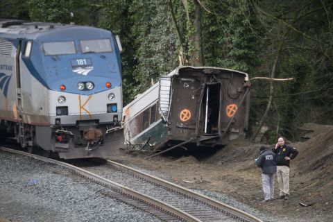 Law enforcement officials work at the scene of the derailment on December 18. The train was making the first trip of a new route that goes from Seattle to Portland, Oregon.