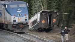 DUPONT, WASHINGTON - DECEMBER 18:  Law enforcement work at the scene of a Amtrak train derailment on December 18, 2017 in DuPont, Washington. At least six people were killed when a passenger train car plunged from the bridge. The derailment also closed southbound I-5.  (Photo by Stephen Brashear/Getty Images)