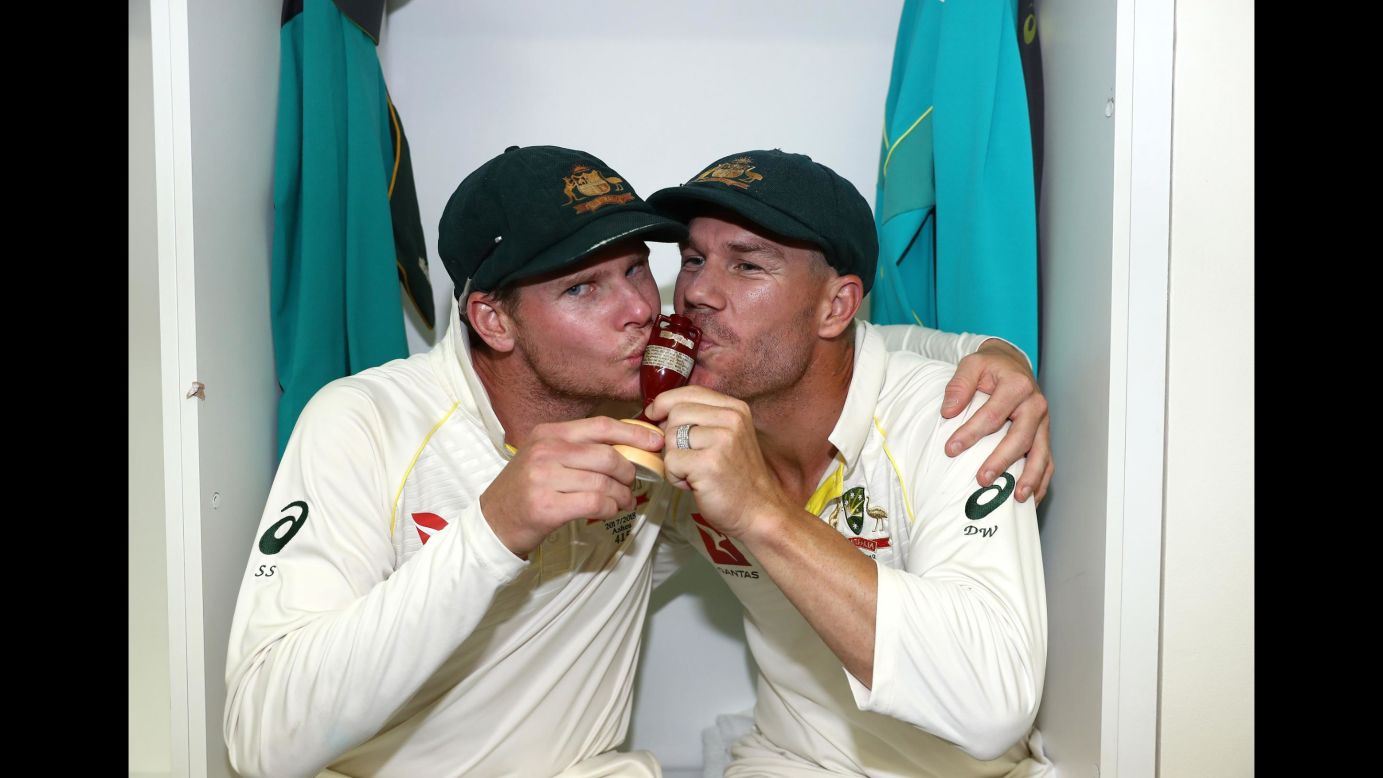 Australian cricketers Steve Smith, left, and David Warner celebrate with the Ashes urn after defeating England on Monday, December 18.