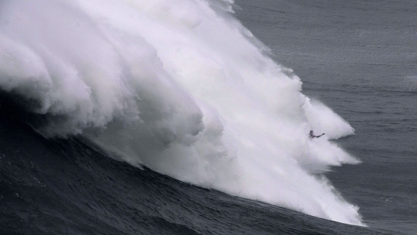 A surfer rides a massive wave in Nazare, Portugal, on Friday, December 15.