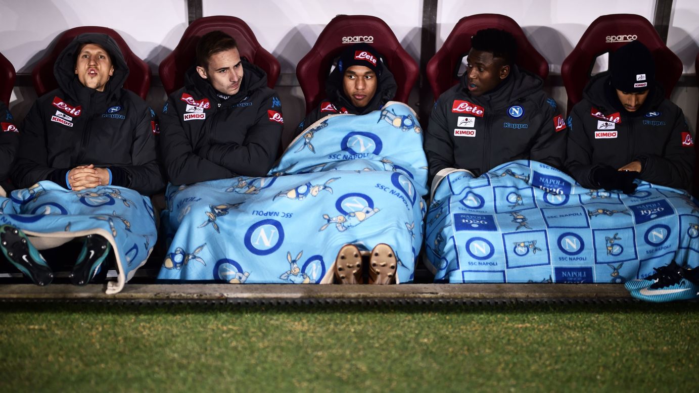 Napoli players cover themselves with blankets before a soccer match in Turin, Italy, on Saturday, December 16.