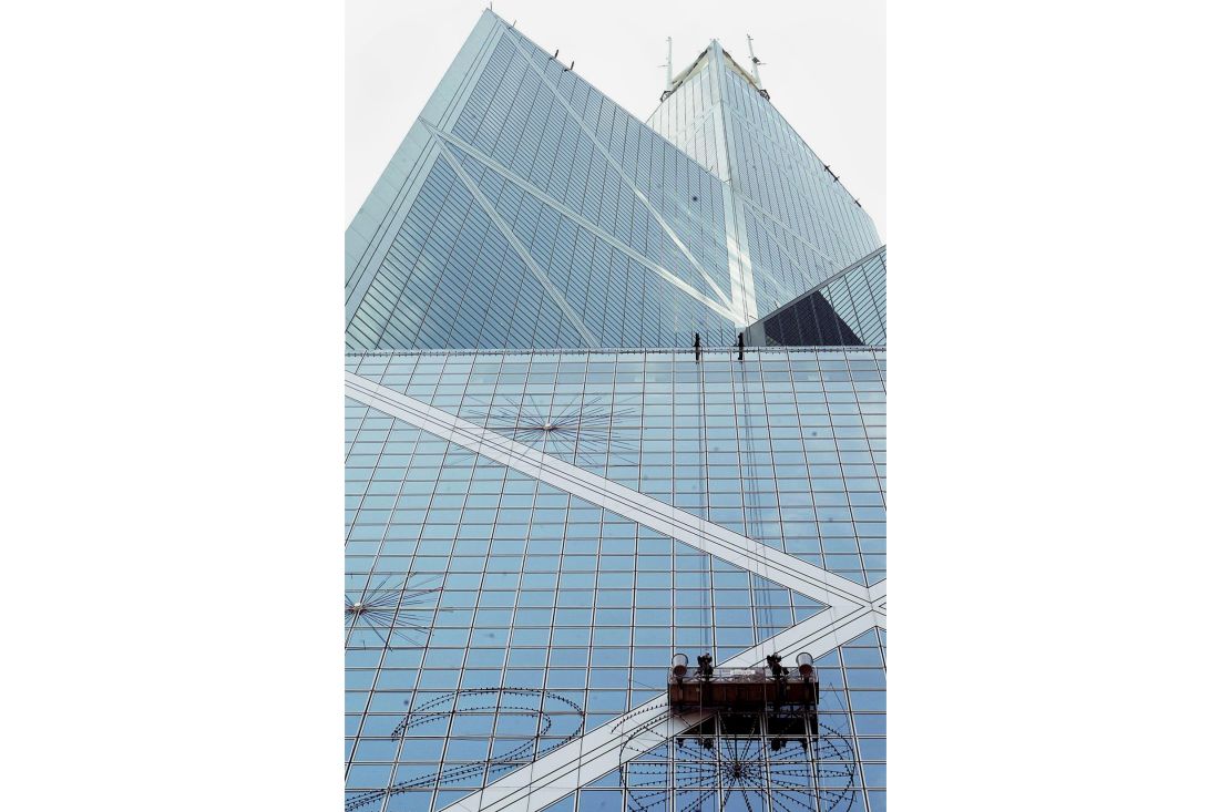 Workers put up Christmas lights on the bank of China Tower in 2002. 