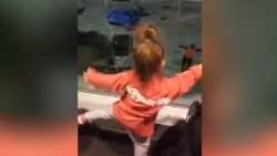 Two little girls have a dance-off with Southwest Airlines employee.