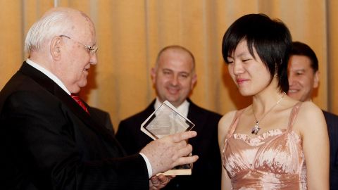 Hou receives the World Women's Chess Champion trophy from former Soviet Union President Mikhail Gorbachev in November 2011. 