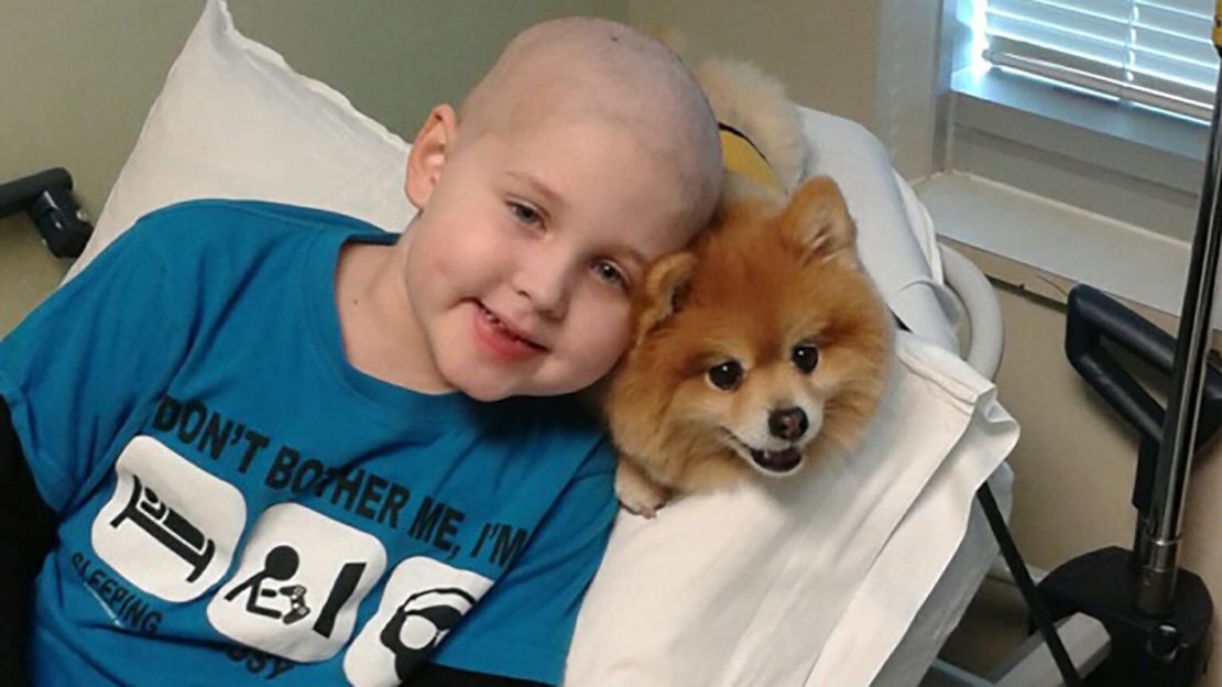 Bryce Greenwell with therapy dog Swoosh during the clinical trial in summer 2014.