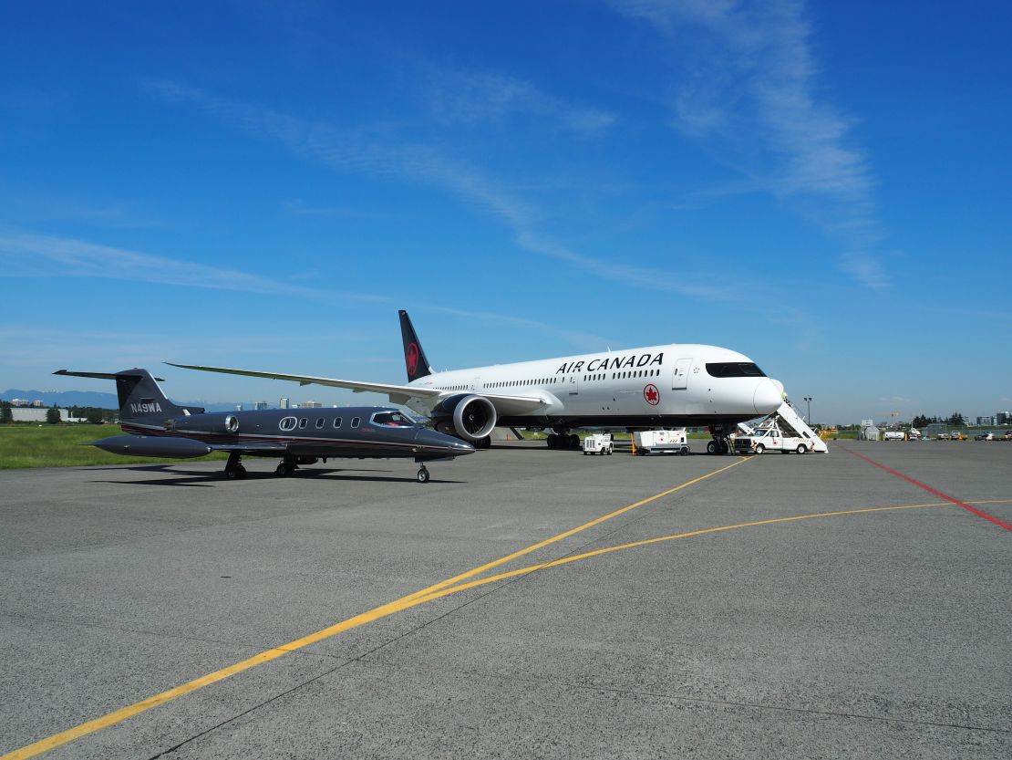 The new Air Canada design took part in a photoshoot in the air -- tailed by a photographer in a  Learjet 25B business jet, pictued left.