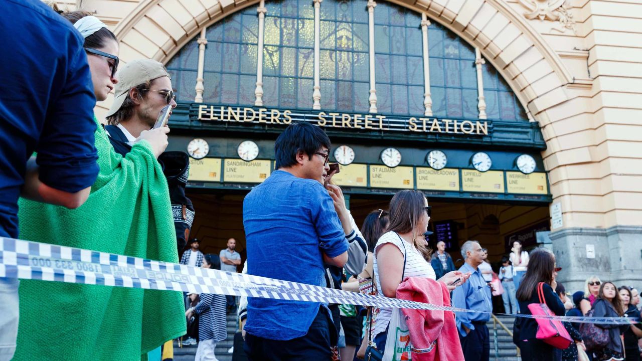 People gather at the scene of where a car ran over pedestrians in Flinders Street in Melbourne on December 21, 2017.