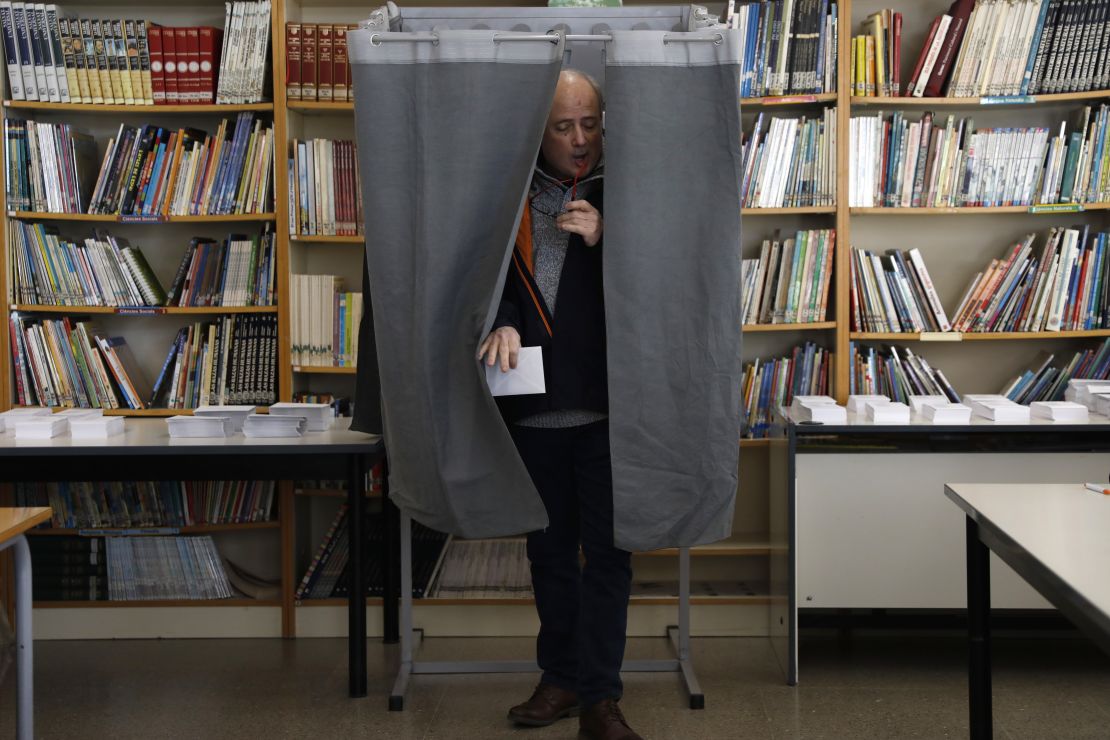 A man leaves a voting booth after casting a ballot on Thursday in Tarragona.  