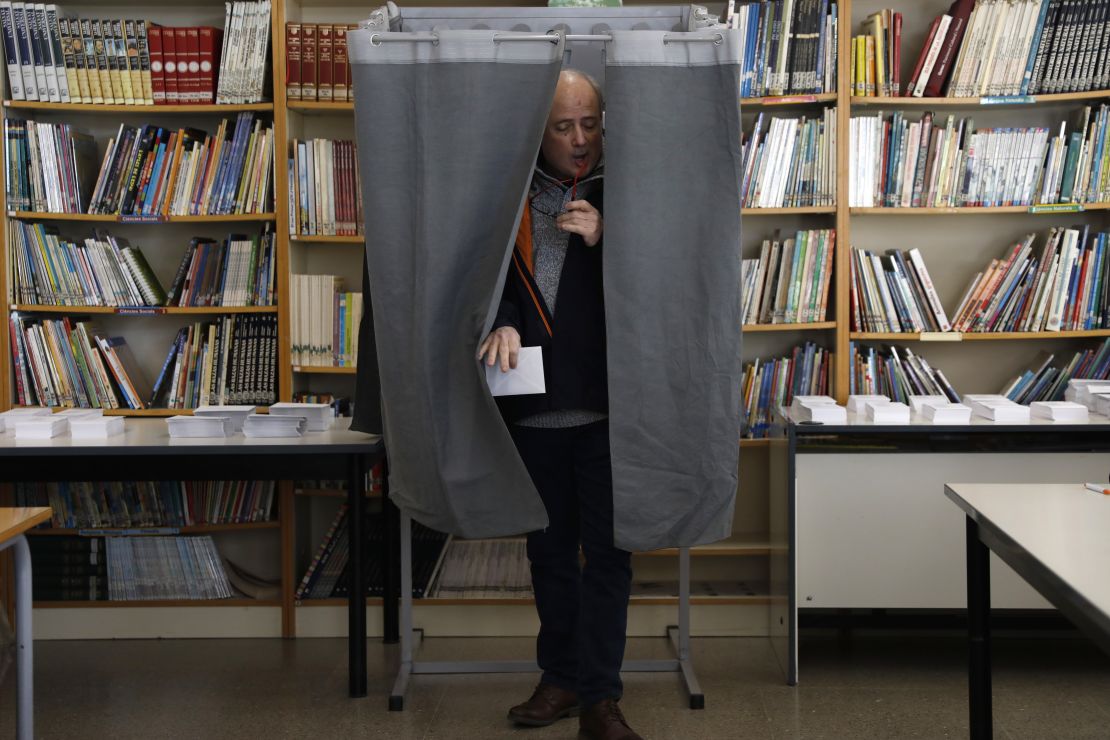 A man leaves a voting booth after casting a ballot on Thursday in Tarragona.