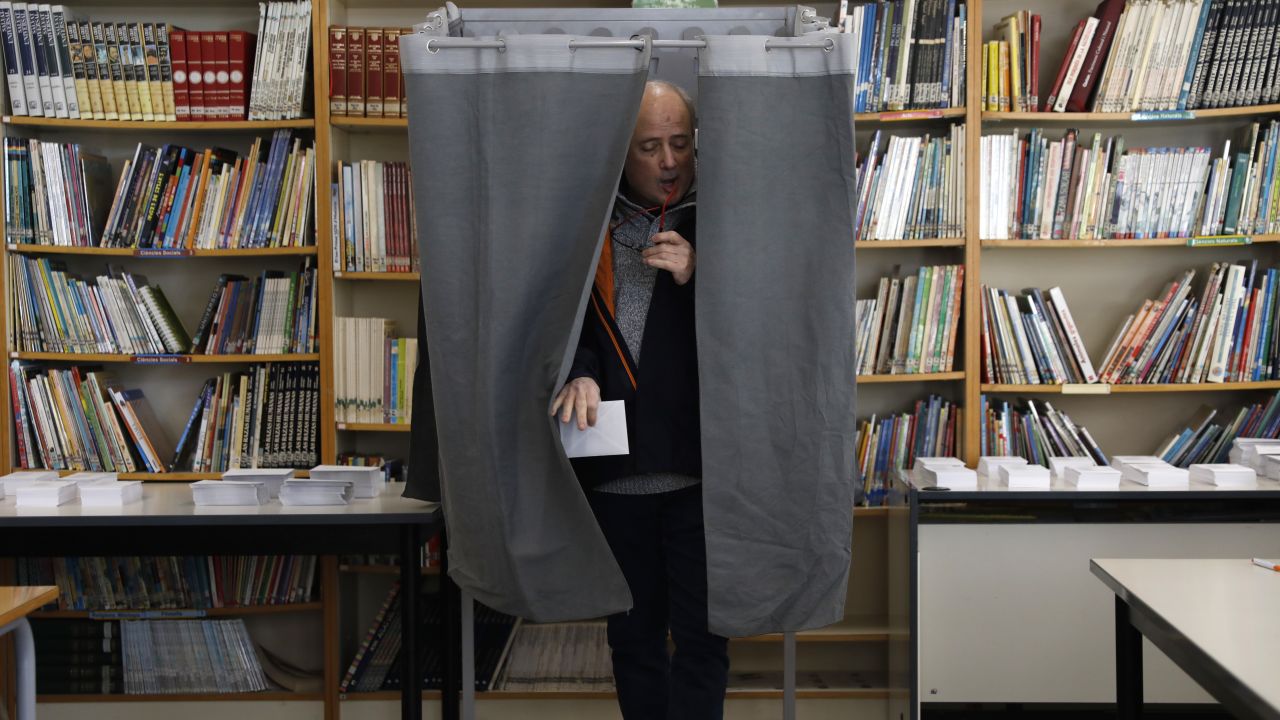A man leaves a voting booth after casting a ballot on Thursday in Tarragona.  
