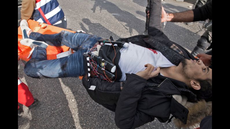 A Palestinian man, wearing what appears to be an explosive belt, is carried into an ambulance on Friday, December 15, after he was shot by Israeli forces in the Ramallah neighborhood of al-Bireh in the West Bank. Israeli police say the man -- identified as Mohammad Ameen Aqel, who later <a href="http://www.cnn.com/2017/12/15/middleeast/jerusalem-protests-friday-intl/index.html" target="_blank">died from his wounds</a> -- was shot after carrying out a stabbing attack on a border police officer during a demonstration. Police have not said whether they believe the belt Aqel was wearing was real or fake. Protests have reignited in the region following a decision by US President Donald Trump to recognize Jerusalem as the capital of Israel.