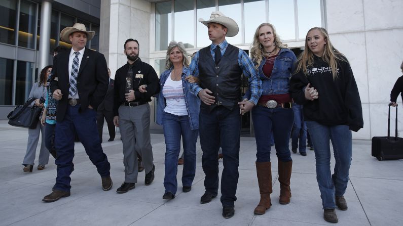A group walks out of a federal courthouse in Las Vegas on Wednesday, December 20. From left are Ammon Bundy, Ryan Payne, Jeanette Finicum, Ryan Bundy, Angela Bundy, and Jamie Bundy. Chief US District Judge Gloria Navarro declared a mistrial Wednesday in the case against Cliven Bundy, his sons Ryan and Ammon, and Payne. In <a href="http://www.cnn.com/2016/02/16/us/cliven-bundy-bail-hearing-oregon/index.html" target="_blank">February 2016</a>, embattled rancher Cliven Bundy and four others -- including his sons, who led the takeover of the Malheur National Wildlife Refuge in Oregon -- were indicted by a federal grand jury on charges stemming from a 2014 armed standoff.