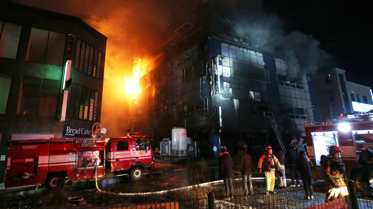 Firefighters work to put out a blaze at an eight-story building in South Korea on Thursday.