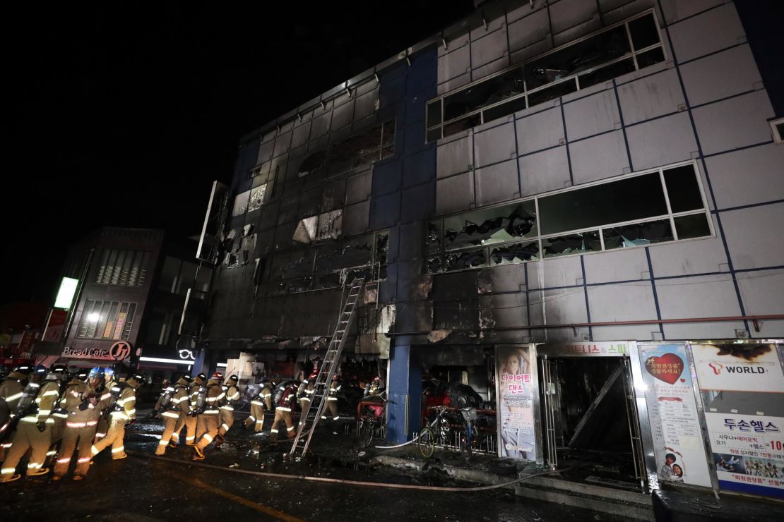 Firefighters make their way into a building on December 21, 2017 in Jecheon, South Korea. 
