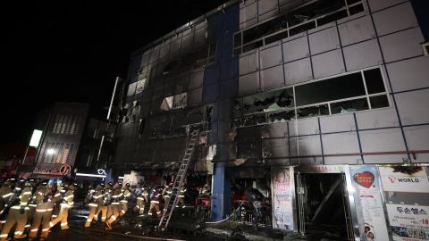 Firefighters make their way into a building on December 21, 2017 in Jecheon, South Korea. 