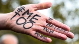 A picture shows the messages "#Me too" and #Balancetonporc ("expose your pig") on the hand of a protester during a gathering against gender-based and sexual violence called by the Effronte-e-s Collective, on the Place de la Republique square in Paris on October 29, 2017.#MeToo hashtag, is the campaign encouraging women to denounce experiences of sexual abuse that has swept across social media in the wake of the wave of allegations targeting Hollywood producer Harvey Weinstein. / AFP PHOTO / BERTRAND GUAY        (Photo credit should read BERTRAND GUAY/AFP/Getty Images)