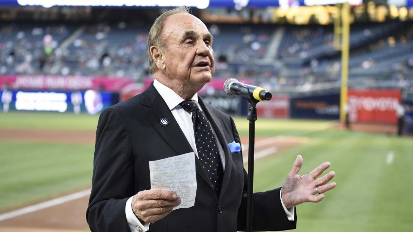 SAN DIEGO, CALIFORNIA - SEPTEMBER 29:  San Diego Padres announcer Dick Enberg talks to the crowd during a ceremony held before a baseball game between the San Diego Padres and the Los Angeles Dodgers at PETCO Park on September 29, 2016 in San Diego, California. The Padres held the pre-game ceremony to honor Enberg's last home game as the team's primary play-by-play man for television broadcasts.  (Photo by Denis Poroy/Getty Images)