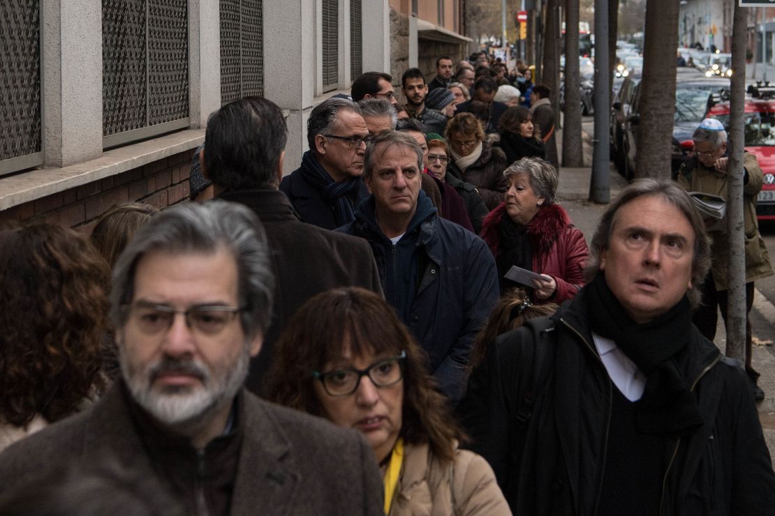 Voters line up outside a polling station in Barcelona, Spain. 