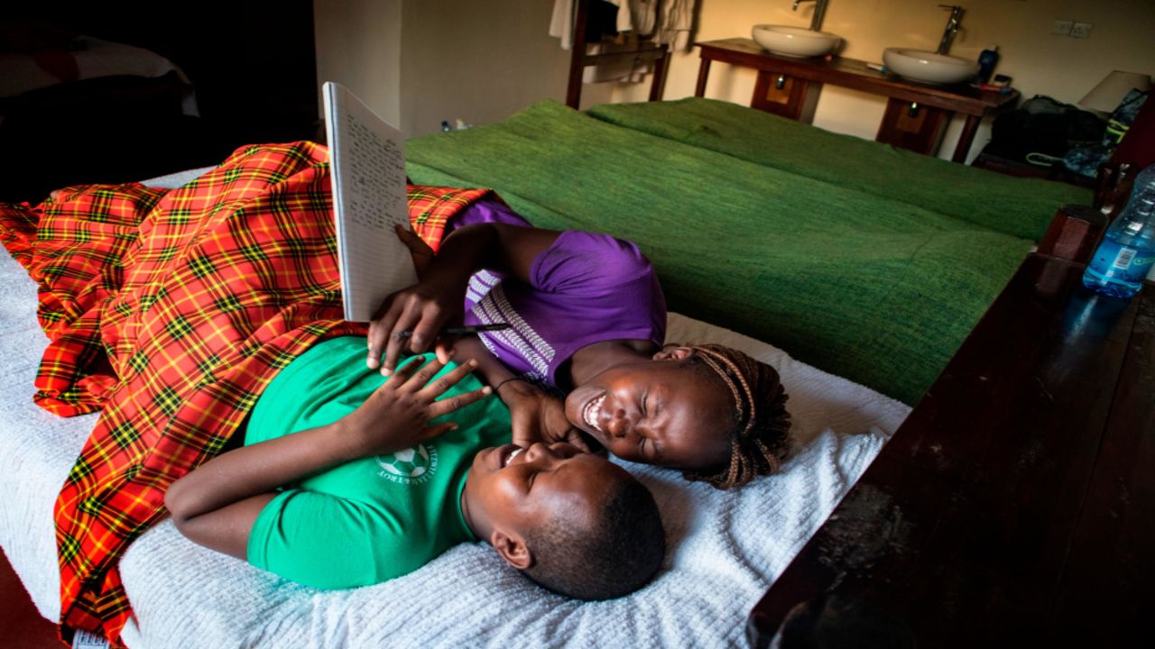 Linnet, left, and Eunice — both 15 — share a laugh in their rooms at the Ngari Hill Eco-Lodge in Maralal, Kenya. "What I tried to show while taking that photo is that the girls are happy because they are studying," said Mary, a 16-year-old who took the photo. (Courtesy Mary/Too Young To Wed)