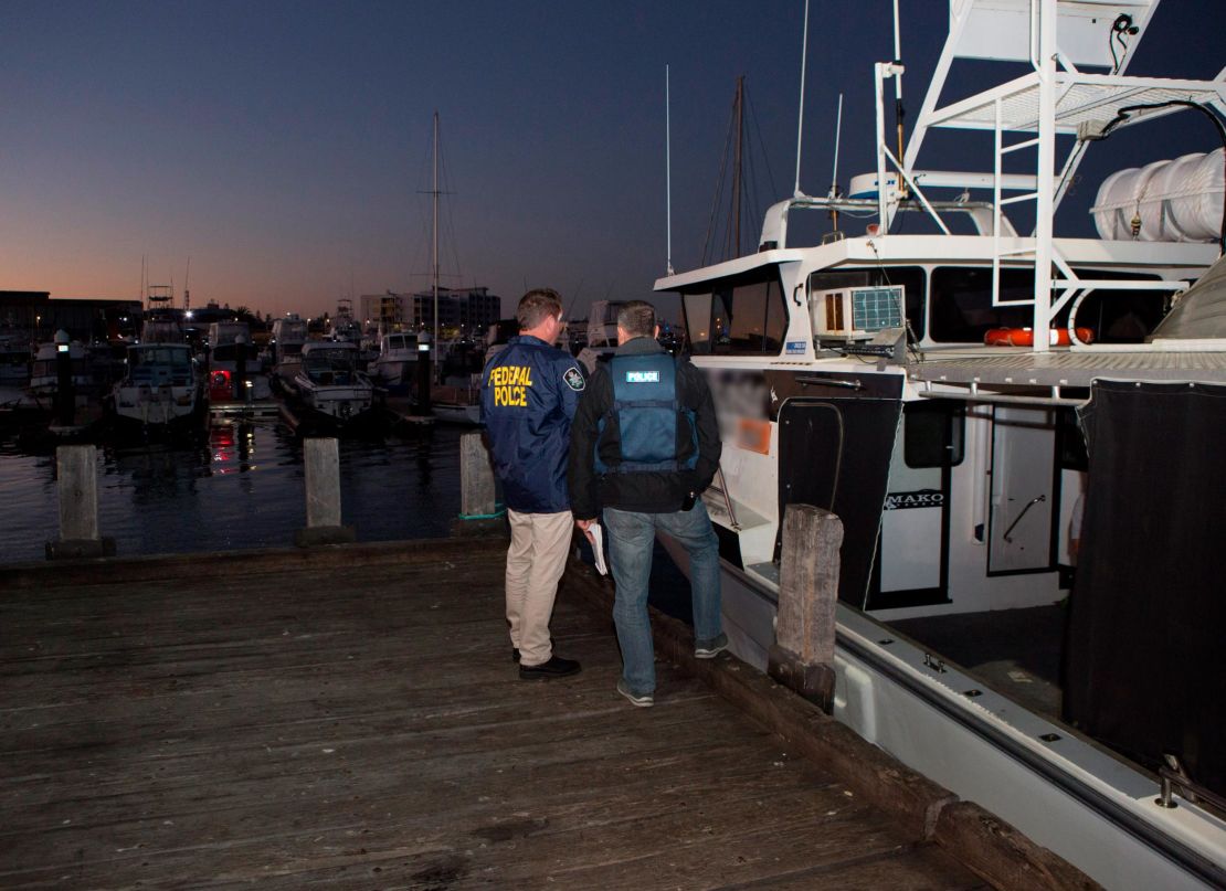 AFP officers stand next to a vessel in the Port of Geraldton, WA.