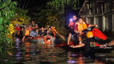Rescue workers evacuate residents in Davao on the southern Philippine island of Mindanao early on the morning of December 23. 