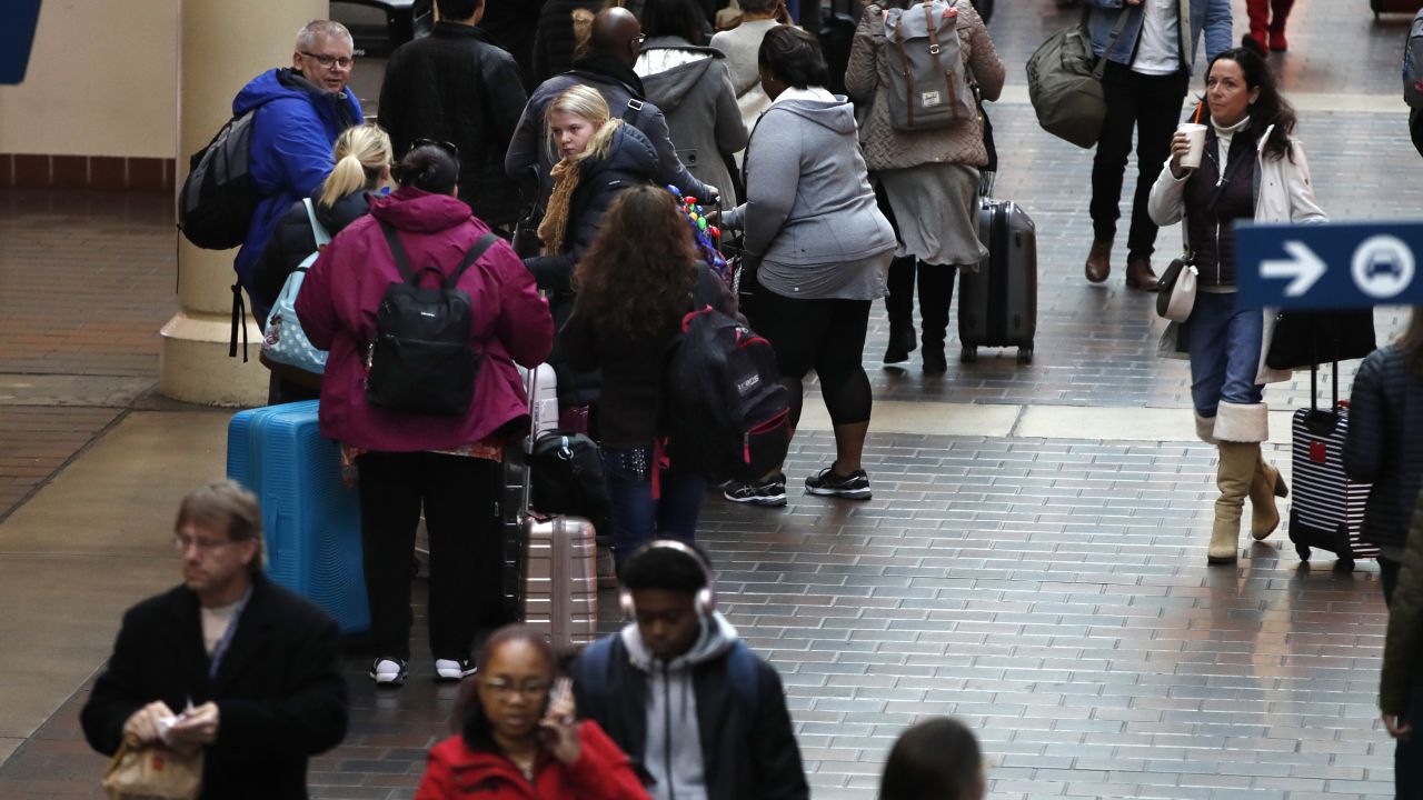Holiday travelers line up Friday to catch a train to Boston from Union Station in Washington.