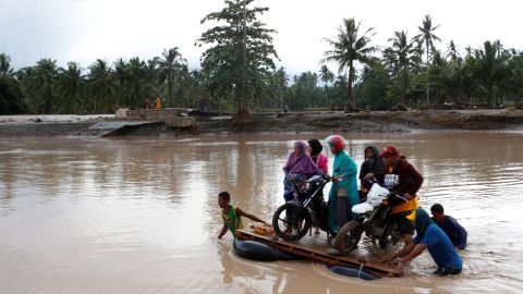Filipino villagers cross a river on makeshift rafts in the town of Salvador, Lanao del Norte province, December 23. 