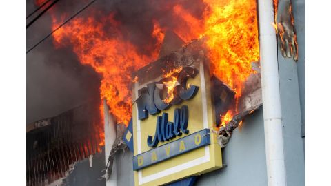 A fire rages at the NCCC shopping mall on Saturday, December 23, 2017, in Davao City.