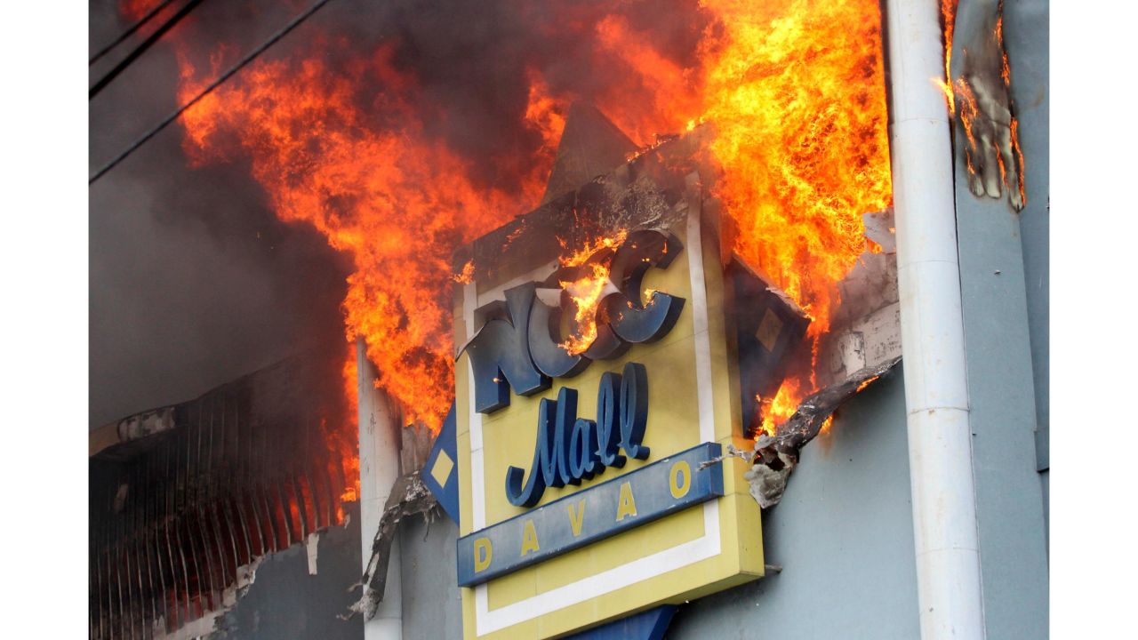 A fire rages at the NCCC shopping mall on Saturday, December 23, 2017, in Davao City.
