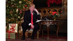 US President Donald J. Trump participates in NORAD Santa Tracker phone calls at the Mar-a-Lago resort in Palm Beach, Florida on December 24, 2017. 
"NORAD Tracks Santa" is an annual Christmas-themed entertainment program, which has existed since 1955, produced under the auspices of the North American Aerospace Defense Command. / AFP PHOTO / Nicholas Kamm        (Photo credit should read NICHOLAS KAMM/AFP/Getty Images)