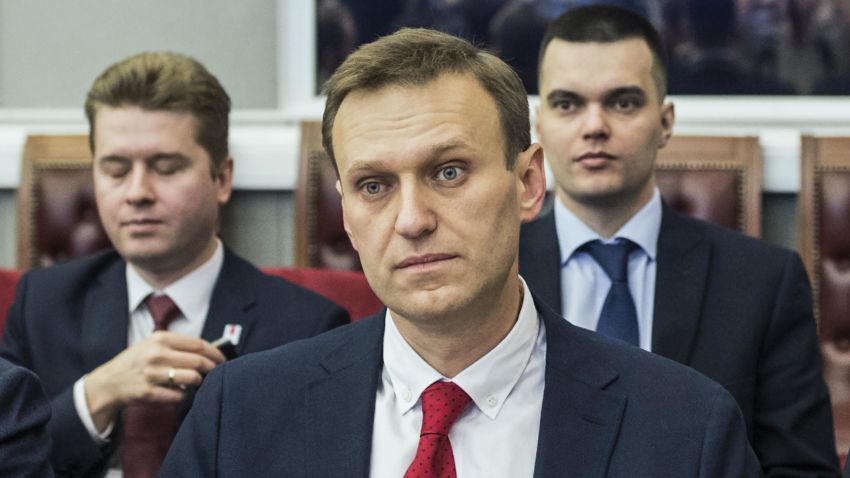 Russian opposition leader Alexei Navalny, who submitted endorsement papers necessary for his registration as a presidential candidate, center, sits at the Russia's Central Election commission in Moscow, Russia, Monday, Dec. 25, 2017. Russian election officials have formally barred Russian opposition leader Alexei Navalny from running for president. (Evgeny Feldman/Navalny Campaign via AP)