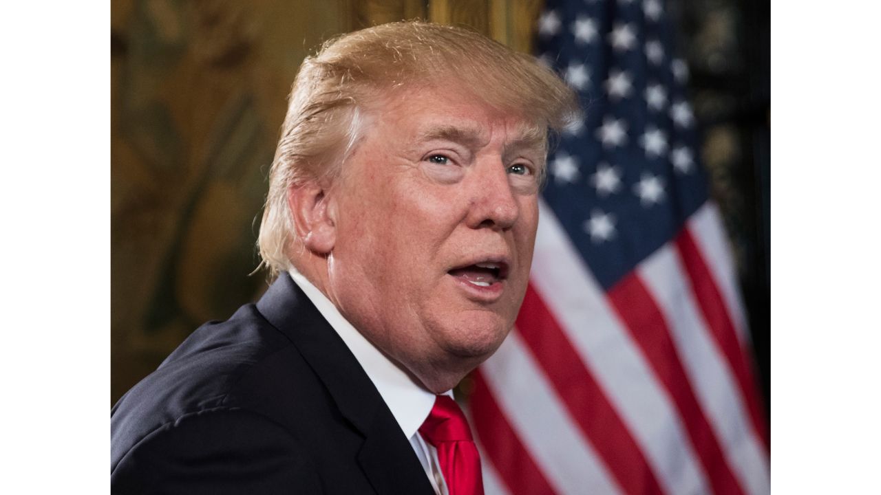 President Donald Trump turns to talk to the gathered media during a Christmas Eve video teleconference with members of the mIlitary at his Mar-a-Lago estate in Palm Beach, Fla., Sunday, Dec. 24, 2017. (AP Photo/Carolyn Kaster)