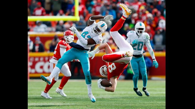 Kansas City tight end Travis Kelce is upended by Miami defensive back Alterraun Verner after making a catch during an NFL game in Kansas City, Missouri, on Sunday, December 24. Kansas City defeated Miami 29-13. 