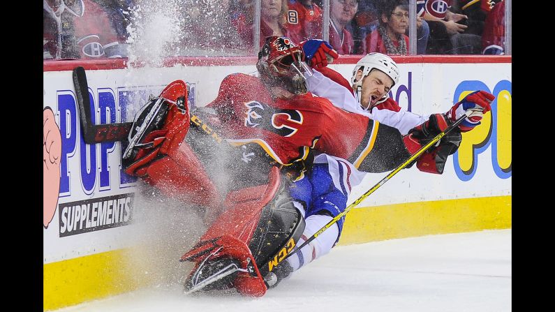 Andrew Shaw of the Montreal Canadiens collides with Calgary Flames' Mike Smith during an NHL game in Calgary, Canada, on Friday, December 22. Montreal won 3-2.