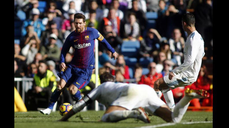 Barcelona's Lionel Messi runs with the ball during a match against Real Madrid in Madrid, Spain, on Saturday, December 23. Messi, who lost one of his boots, went on to assist Aleix Vidal, solidifying Barcelona's 3-0 win.