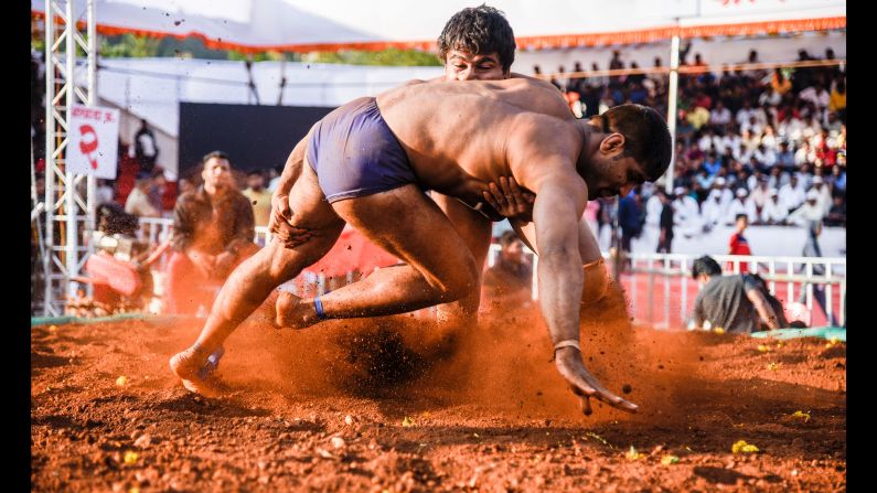 Wrestlers compete in the mud at Maharashtra Kesari, an Indian-style wrestling tournament, in Pune, India, on Thursday, December 21.