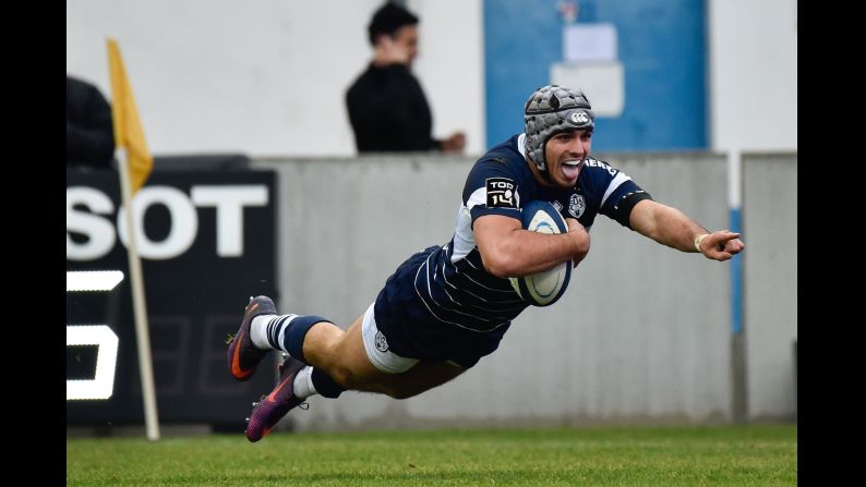 Agen's Clement Laporte jumps to score a try during a French Top 14 rugby union match against Brive in Agen, France, on Saturday, December 23.