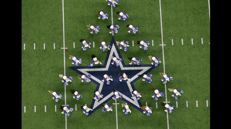 Dallas cheerleaders perform during the first half of an NFL football game against Seattle in Arlington, Texas, on Sunday, December 24.