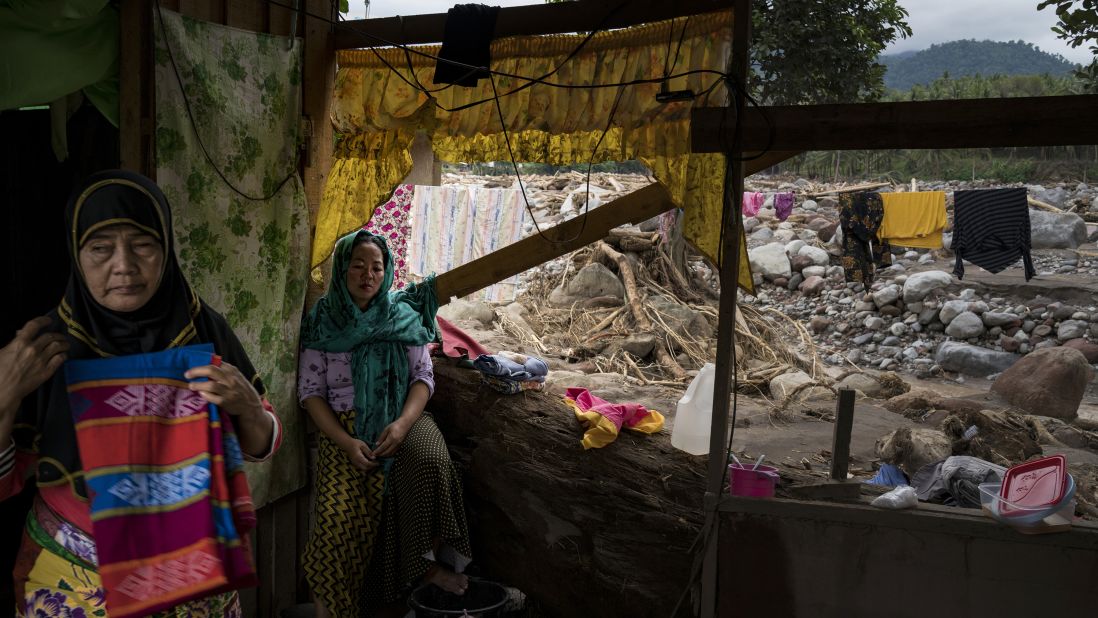 Residents huddle in their devastated house on December 25 in Salvador, Lanao del Norte province.