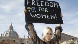 An activist of the Ukrainian female rights organization "Femen" shows a placard during a protest in St. Peter's Square at the Vatican, Sunday, Nov. 6, 2011. (AP Photo/Pier Paolo Cito)