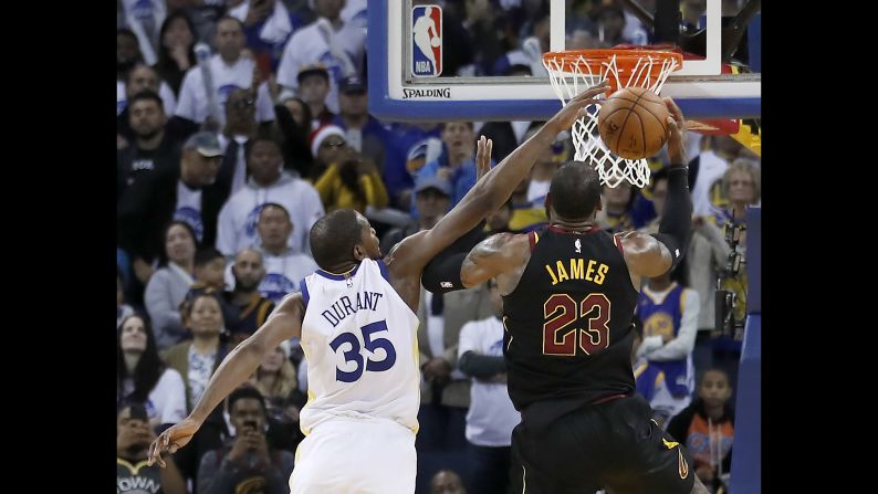 Golden State's Kevin Durant blocks a shot by Cleveland's LeBron James during the second half of an NBA game in Oakland, California on Monday, December 25. Golden State won 99-92. 