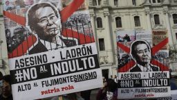 Demonstrators protest against pardon of former President Alberto Fujimori in Lima, Peru, Monday, Dec. 25, 2017. Peru's President Pedro Pablo Kuczynski announced Sunday night that he granted a medical pardon to the jailed former strongman who was serving a 25-year sentence for human rights abuses, corruption and the sanctioning of death squads. The poster reads in spanih: "Assassin, Thief, Not to pardon".(AP Photo/Martin Mejia)
