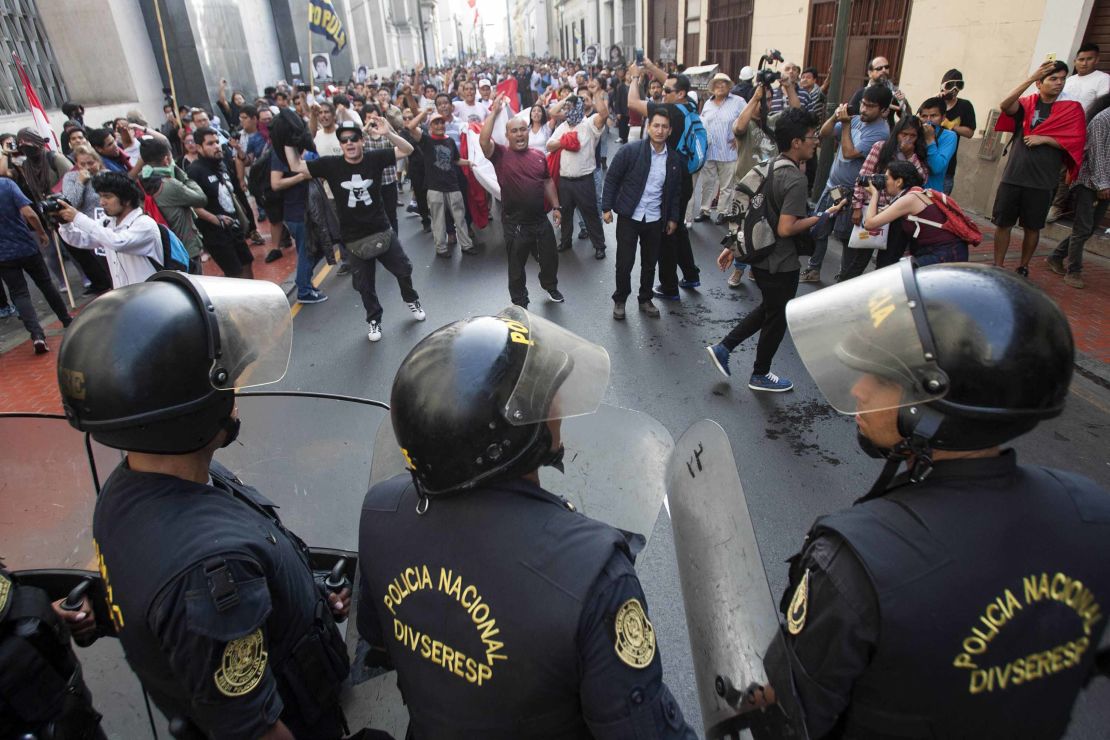 Police and protesters face off during a rally against the pardoning of Alberto Fujimori on Monday.