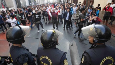 Police and protesters face off during a rally against the pardoning of Alberto Fujimori on Monday.