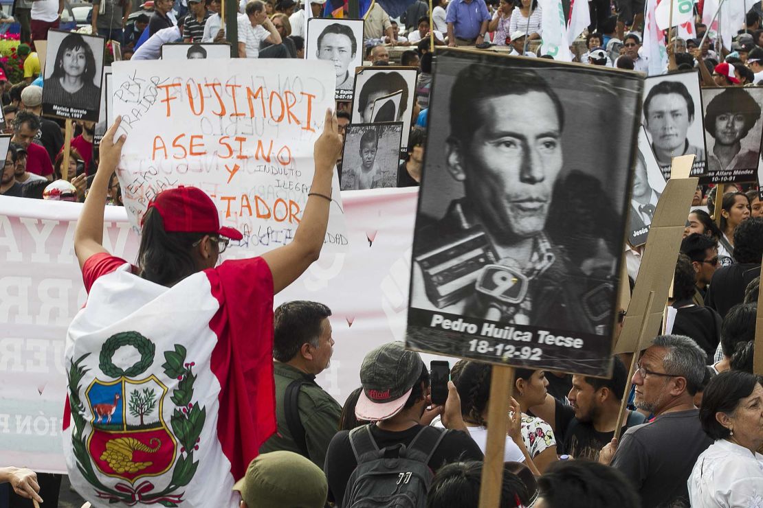 Demonstrators march in Lima on Monday to protest the presidential pardon for Fujimori.