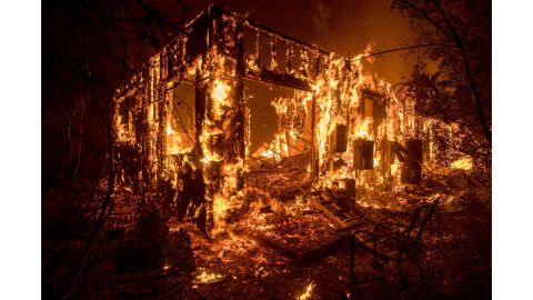 Flames consume a home as a wildfire burns in Ojai on December 7, 2017.
