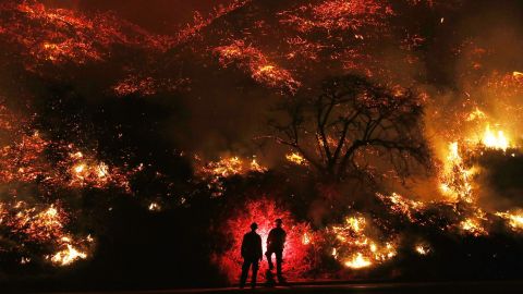  Firefighters monitor a section of the Thomas Fire along the 101 freeway on December 7, 2017 north of Ventura, California. 