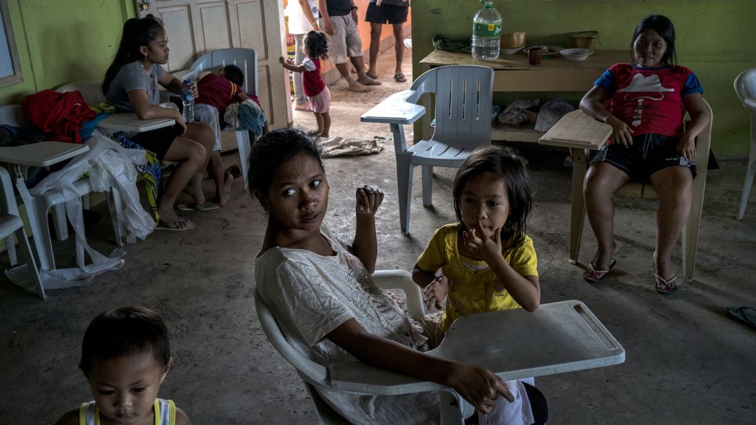 Displaced residents rest at a makeshift evacuation center in a classroom at a private school on December 26 in Tubod, Lanao del Norte. 